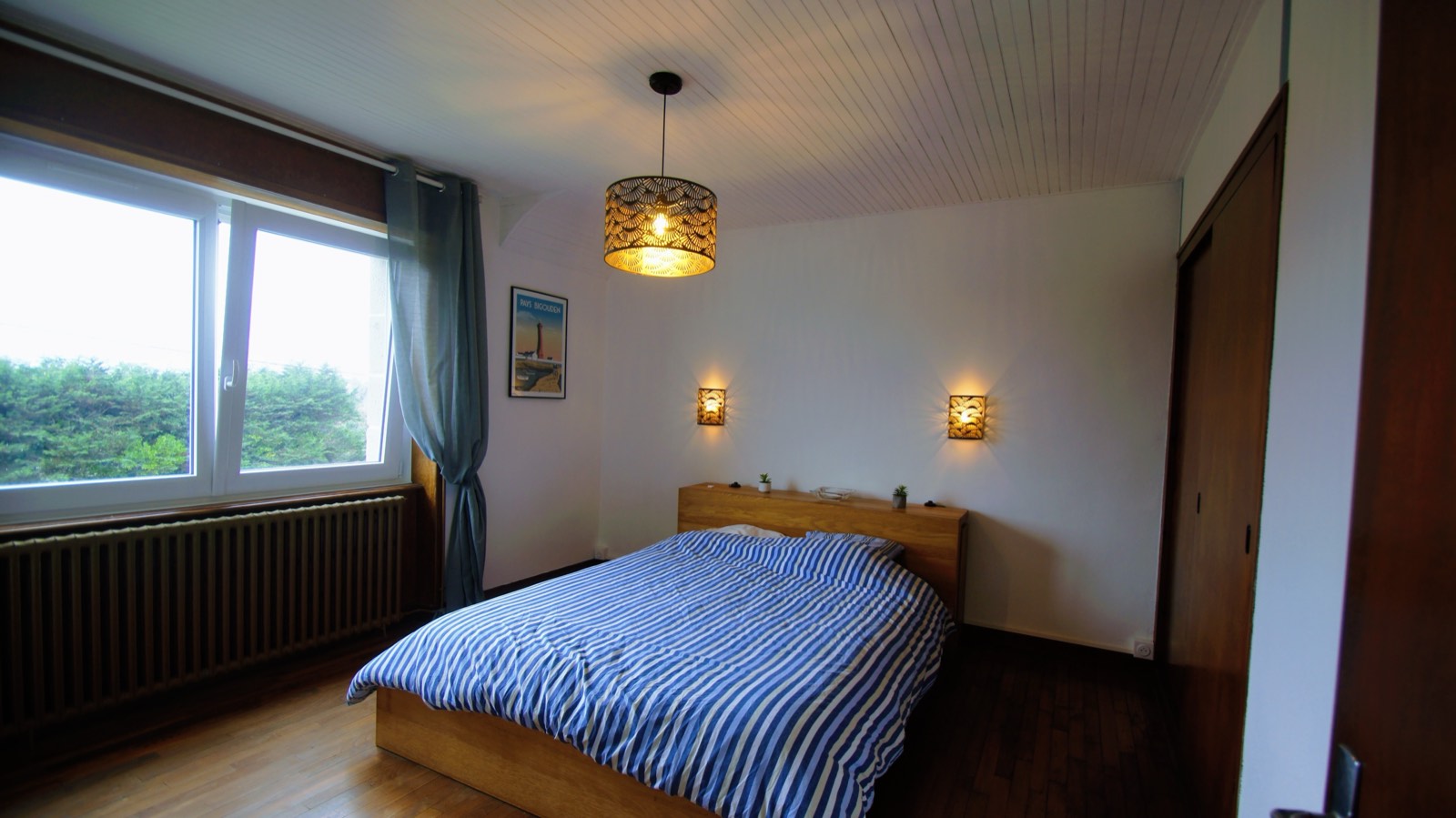 Chambre avec lit double, linge rayé bleu et blanc